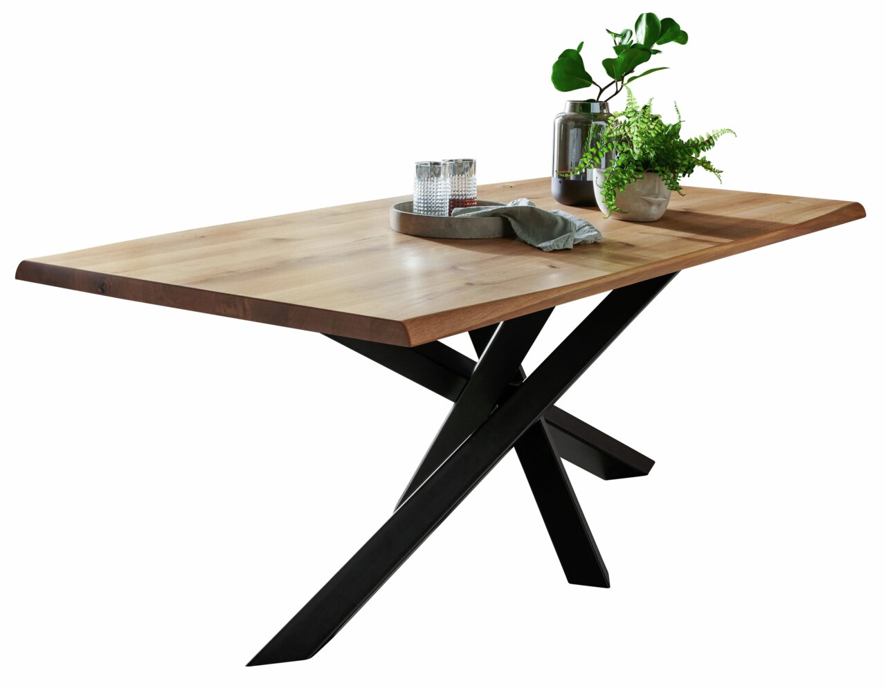Moderne houten eettafel met een zwart metalen onderstel, versierd met planten en glazen, zijaanzicht