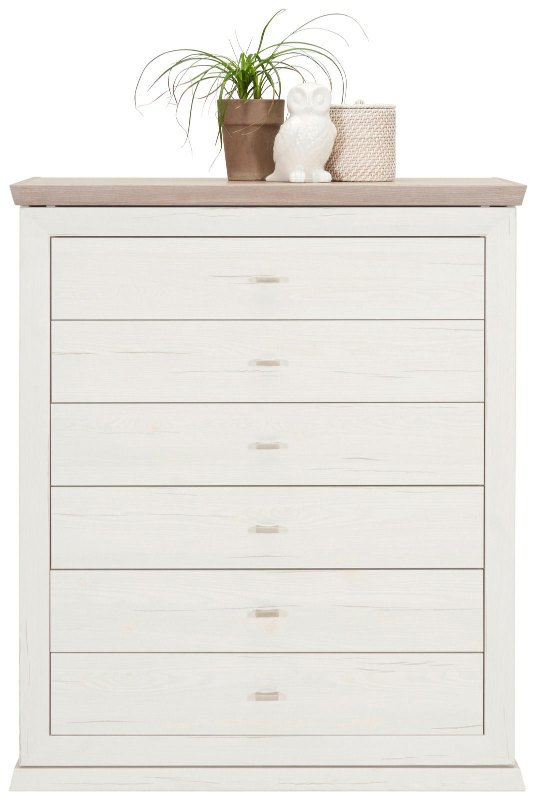 Weiße Kommode mit sechs Schubladen, dekoriert mit einer Pflanze, einer Eulenfigur und einem Korb auf der Oberseite, Frontalansicht.
