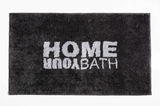Schwarzer Badteppich mit der Aufschrift 'HOME YOUR BATH' in weißer Schrift, von oben betrachtet.