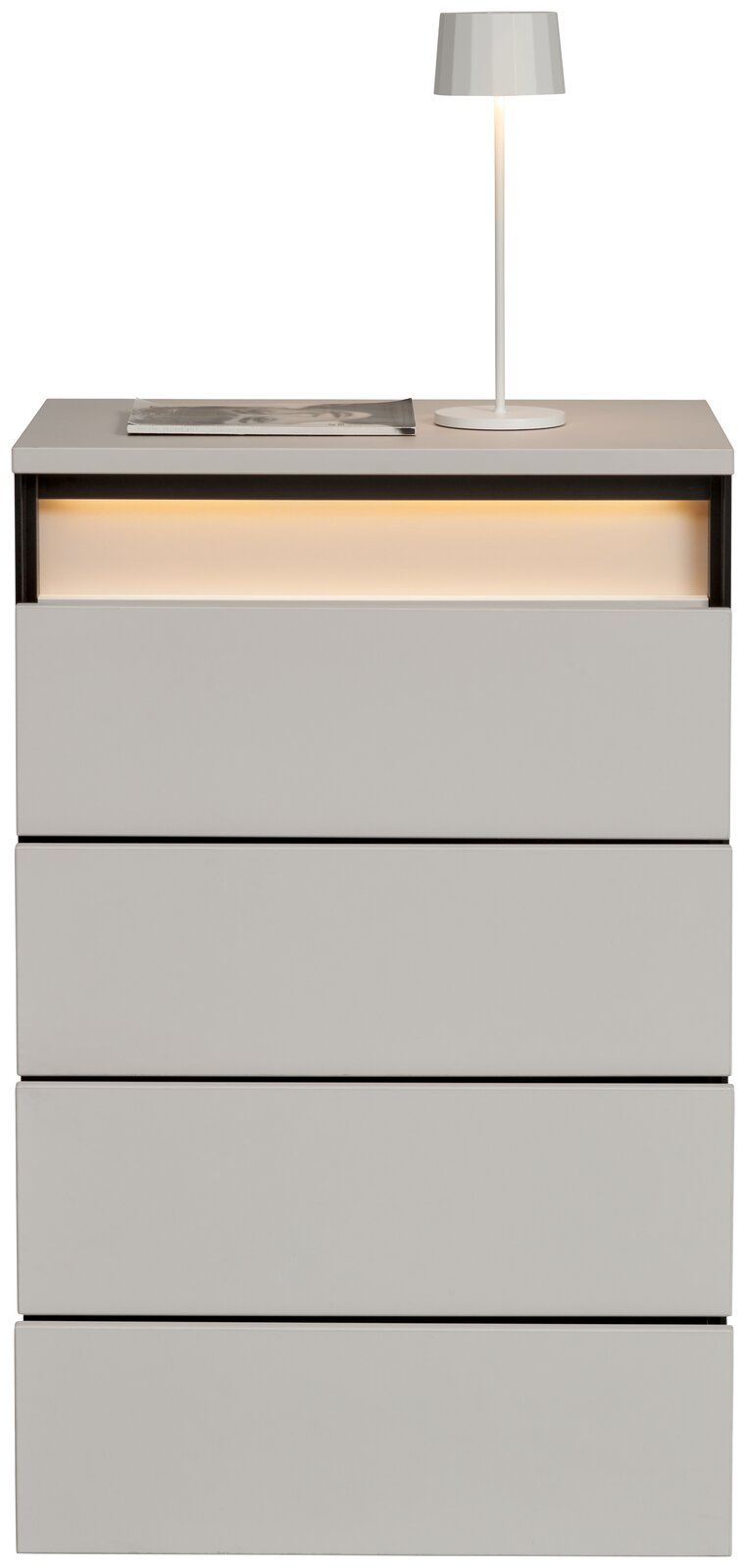 Hochkommode mit vier Schubladen, moderne graue Oberfläche, beleuchtetes Fach oben, Ansicht von vorne, dekoriert mit einer Tischlampe und einem Buch.