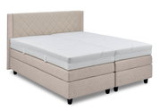 Boxspringbed in beige met doorgestikt hoofdeinde, zijaanzicht