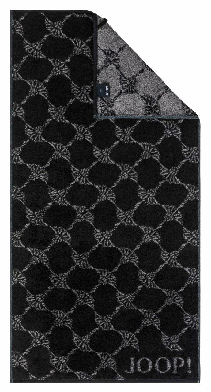 Schwarzes Duschtuch mit grauem geometrischem Muster und der Aufschrift 'JOOP!' in der unteren rechten Ecke, aus der Vogelperspektive fotografiert.