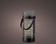 Zylindrische Solar-Laterne aus Acryl mit schwarzem Griff, beleuchtet mit kleinen Lichtern, seitliche Perspektive