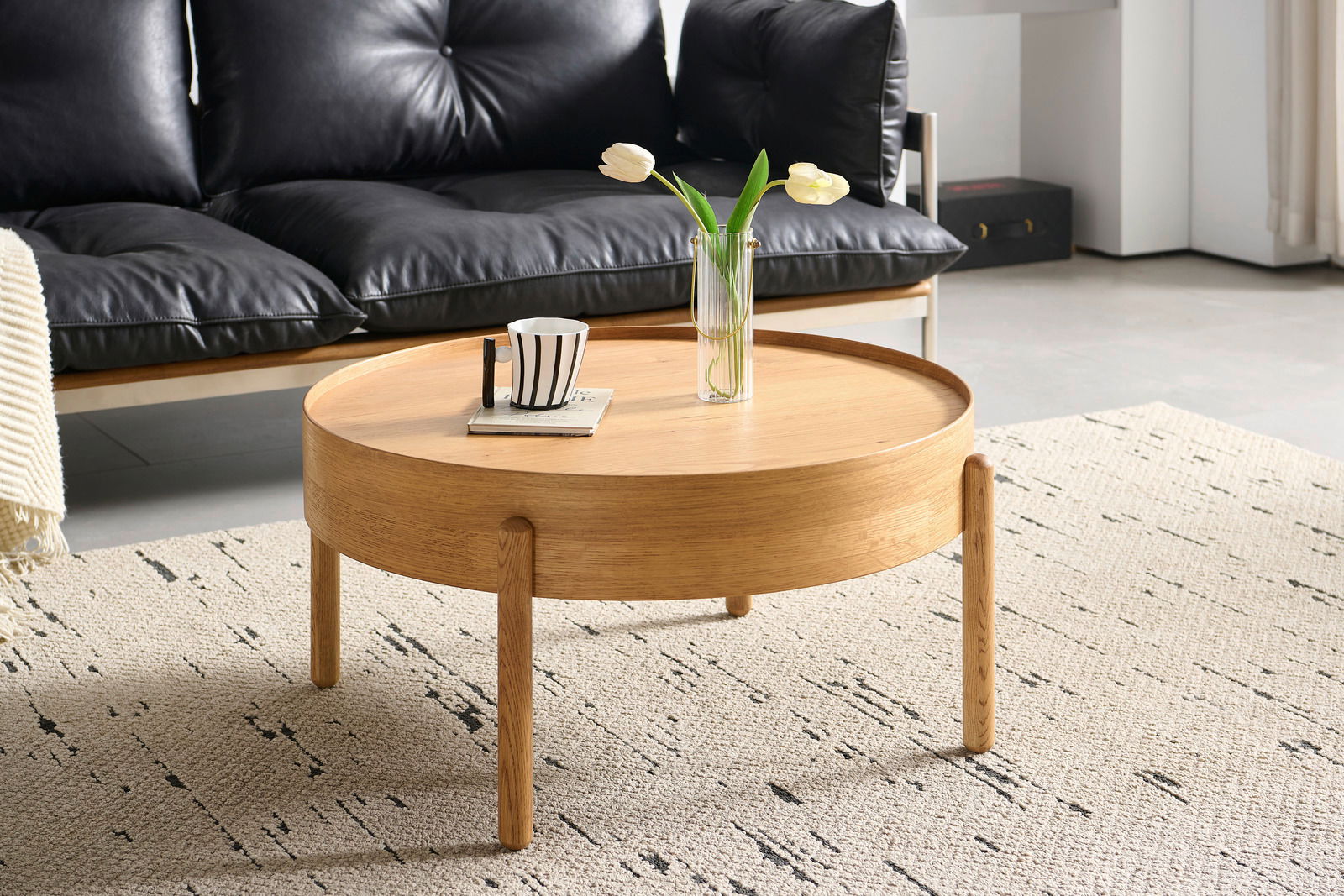 Runder Couchtisch aus Holz in einem modernen Wohnzimmer, seitliche Perspektive