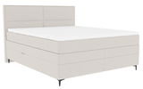 Boxspringbett in seitlicher Perspektive mit hellem Stoffbezug und schlichtem Design