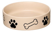Beige Hundenapf mit schwarzen Pfotenabdrücken und Knochenmotiven, seitliche Perspektive