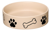 Beige Hundenapf mit schwarzen Pfotenabdrücken und Knochenmotiven, seitliche Perspektive