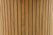 Nahaufnahme von vertikalen Holzlatten mit natürlicher Maserung, aus der Perspektive von oben betrachtet.