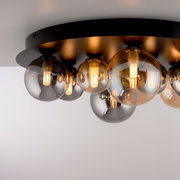 Moderne LED-Deckenleuchte mit mehreren kugelförmigen Glühbirnen auf einer schwarzen Basis, seitliche Perspektive