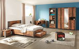 Schlafzimmer mit modernem Holzbett, Schreibtisch und Kleiderschrank in warmer Holzoptik, seitliche Perspektive.