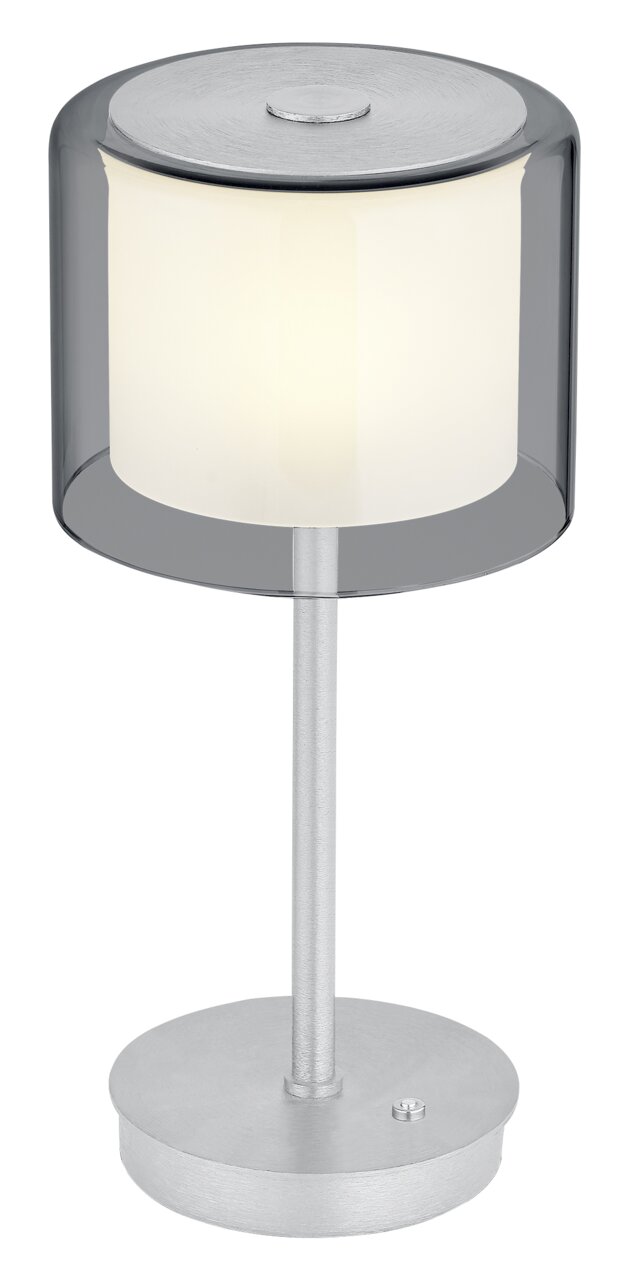 Moderne LED-Tischleuchte KLARA mit zylindrischem, transparentem Schirm und silbernem Standfuß, seitliche Perspektive.