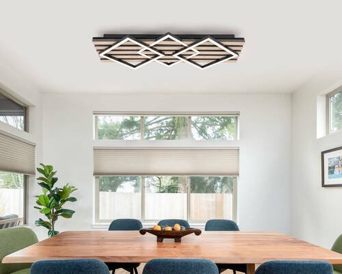 Moderne LED-Deckenleuchte in geometrischem Design, montiert an der Decke eines Esszimmers, aus der Perspektive des Raumes betrachtet.