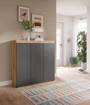 Modernes Sideboard mit Holzrahmen und anthrazitfarbenen Fronten im Flur, dekoriert mit Vase und Bildern an der Wand, Frontansicht in leichter Schrägperspektive von links