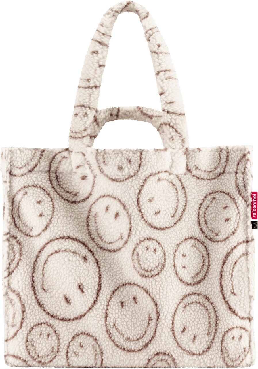 Frontansicht einer cremefarbenen, flauschigen Teddy-Shopper-Tasche mit braunem Smileys-Print und zwei kurzen Tragehenkeln vor weißem Hintergrund