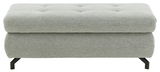 Grauer XXL-Hocker mit gepolsterter Oberfläche und schwarzen Metallbeinen, Frontalansicht.