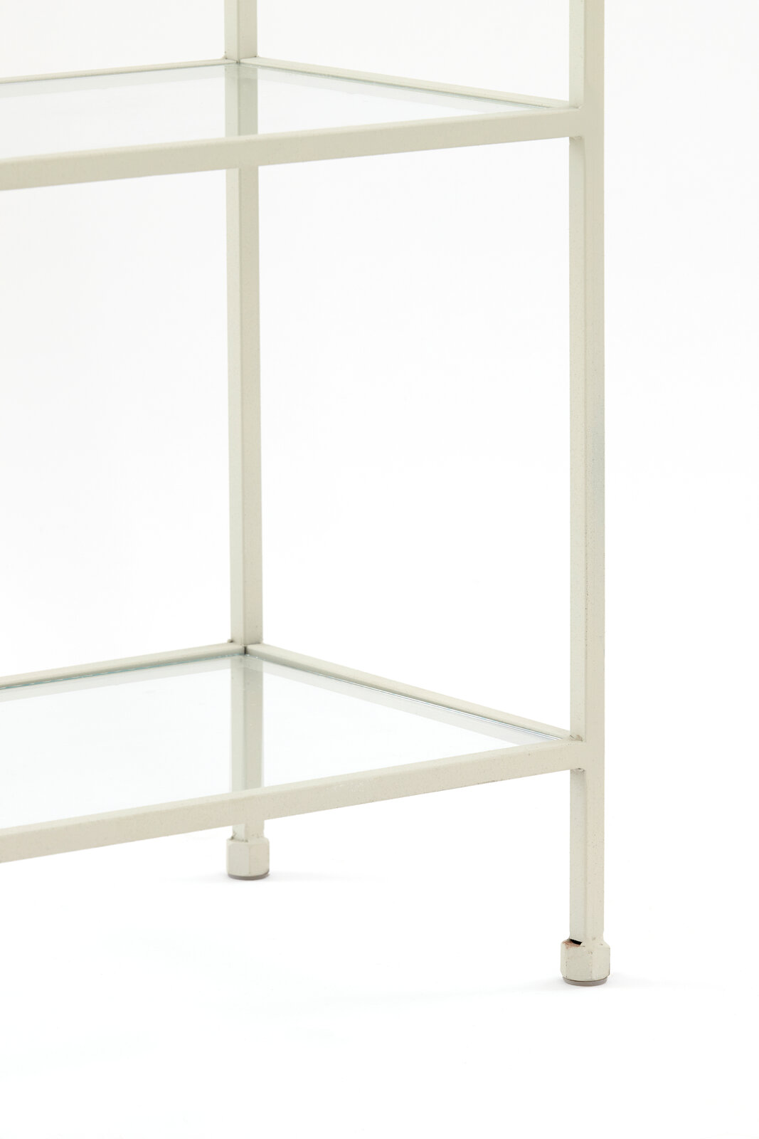 Nahaufnahme eines weißen Standregals mit Glasböden, seitliche Perspektive.