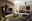 Moderne Wohnzimmer-Wandkombination in dunklen Tönen mit integrierter Beleuchtung, bestehend aus Hängeschränken, TV-Board und Vitrine, aus der Perspektive eines gemütlichen Wohnzimmers mit Sofa und Teppich.