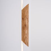 LED-Wandleuchte aus Holz in seitlicher Perspektive mit warmem Lichtschein nach oben und unten.