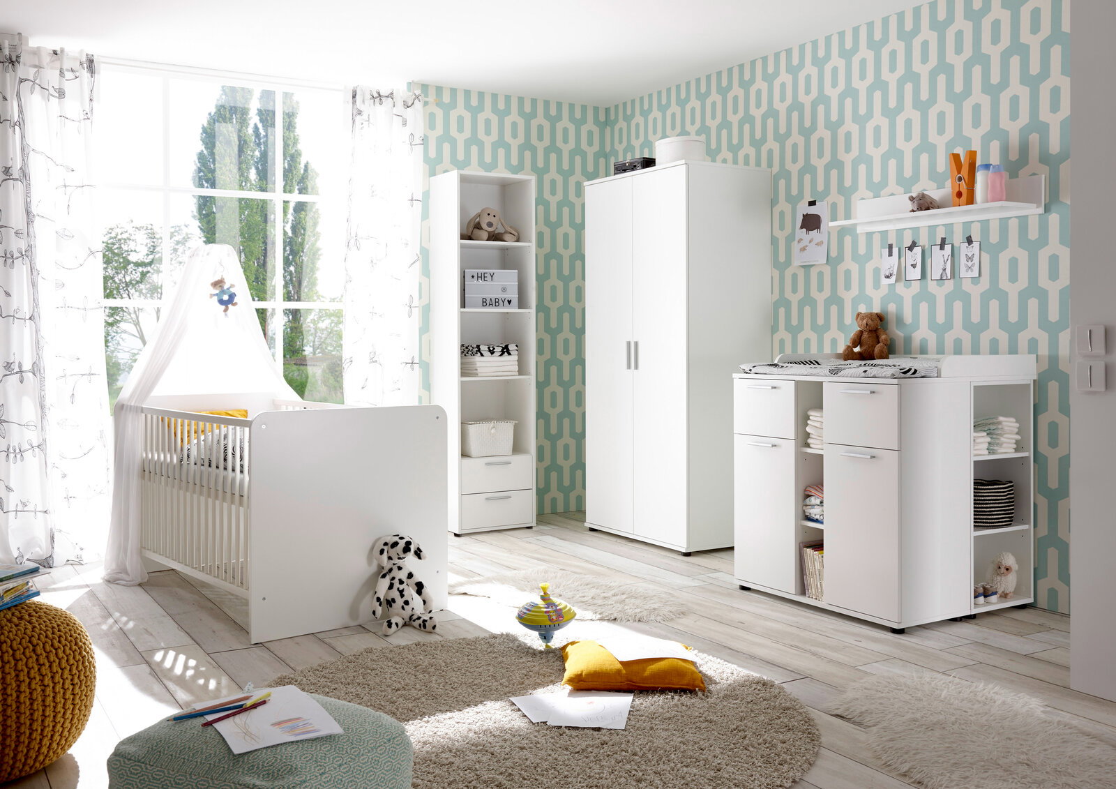 Helles Kinderzimmer mit weißem Gitterbett, Wickelkommode und Schrank in moderner Einrichtung, seitliche Perspektive.