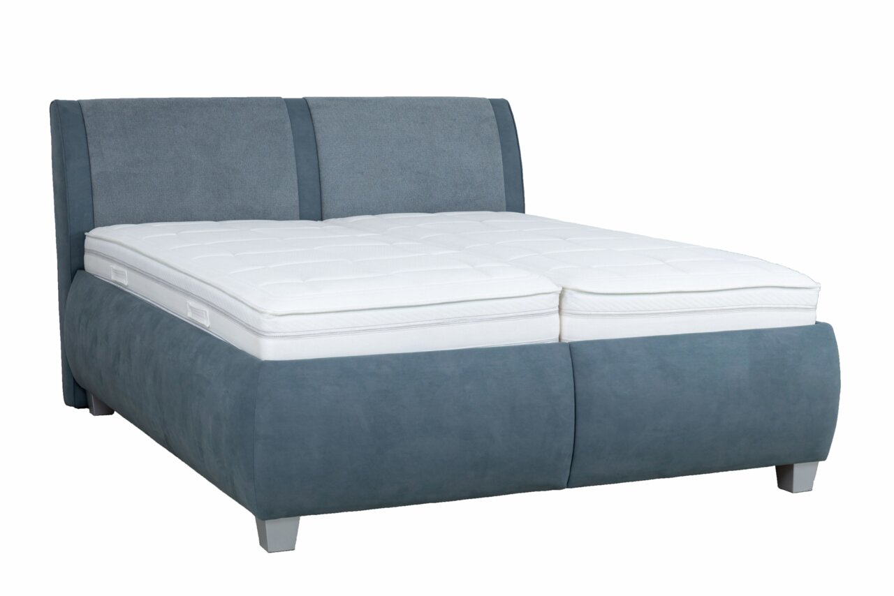 Polsterbett in blauer Farbe mit weißer Matratze, seitliche Perspektive