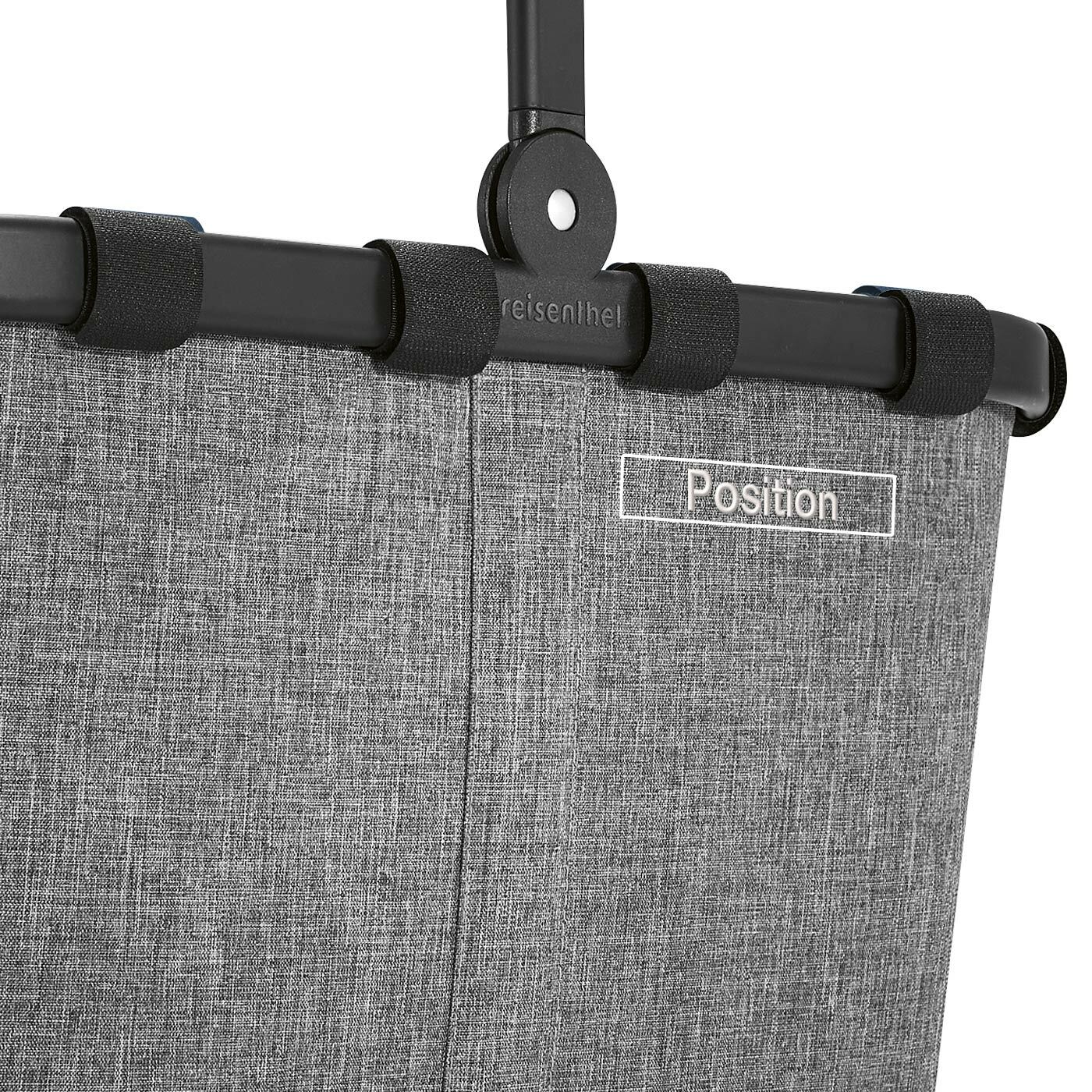 Nahaufnahme des oberen Teils eines grauen Carrybag-Rahmens mit schwarzem Griff und Text 'Position'.