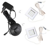 Unterbaubeleuchtung Set mit zwei quadratischen LED-Leuchten, Kabeln und Netzteil, aus der Vogelperspektive.