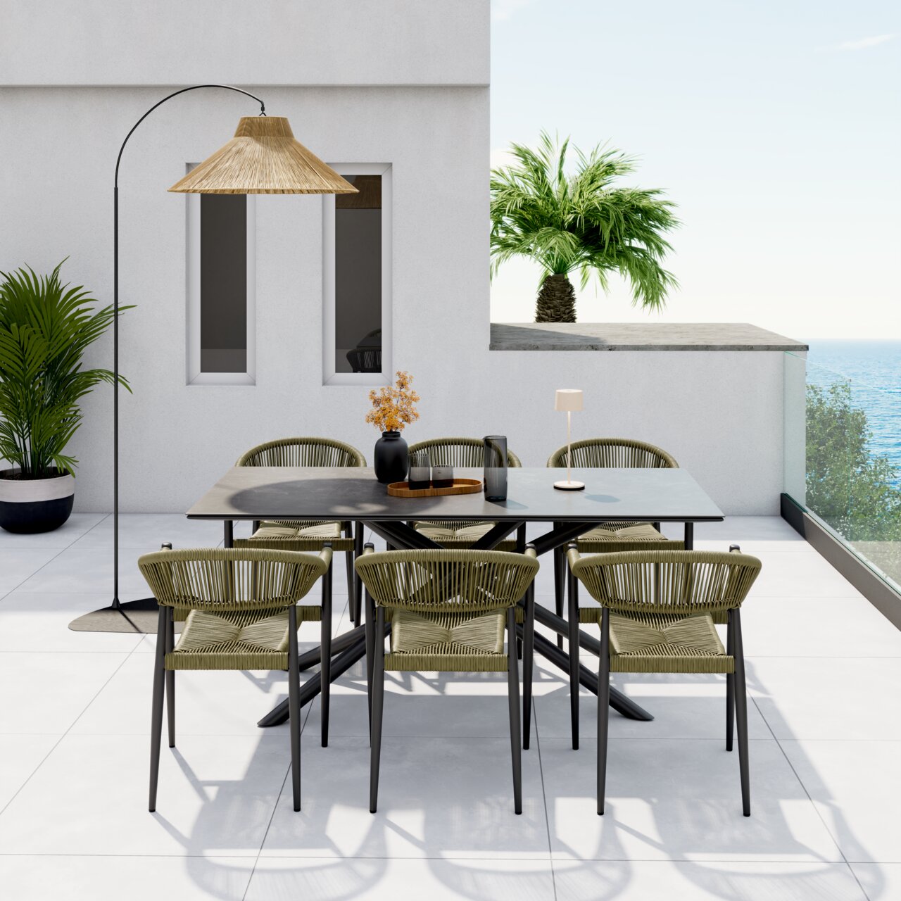 Een moderne stapelstoel op een terras met uitzicht op zee, omringd door een stijlvolle eettafel en planten, gezien vanaf de voorkant.