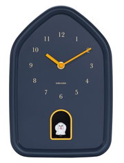 Moderne wandklok in de vorm van een huisje met gele wijzers en een klein figuurtje onderaan in het midden, gezien van voren.