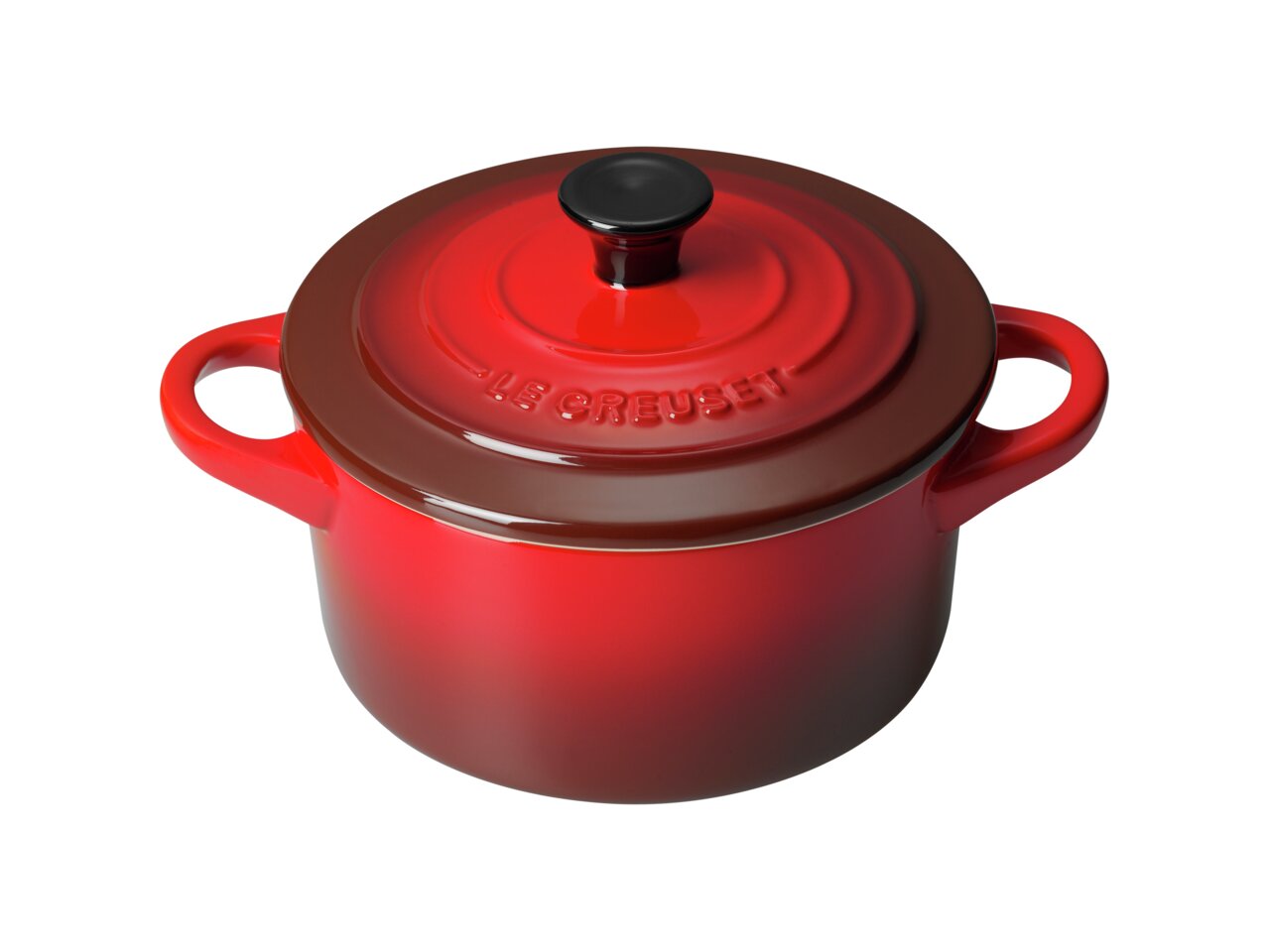 Rote Le Creuset Mini-Cocotte aus der Vogelperspektive mit zwei Griffen und schwarzem Knauf auf dem Deckel.