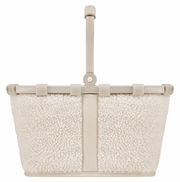 Kleiner, cremefarbener Korb mit weichem, flauschigem Stoff und stabilem Griff, frontal abgebildet.