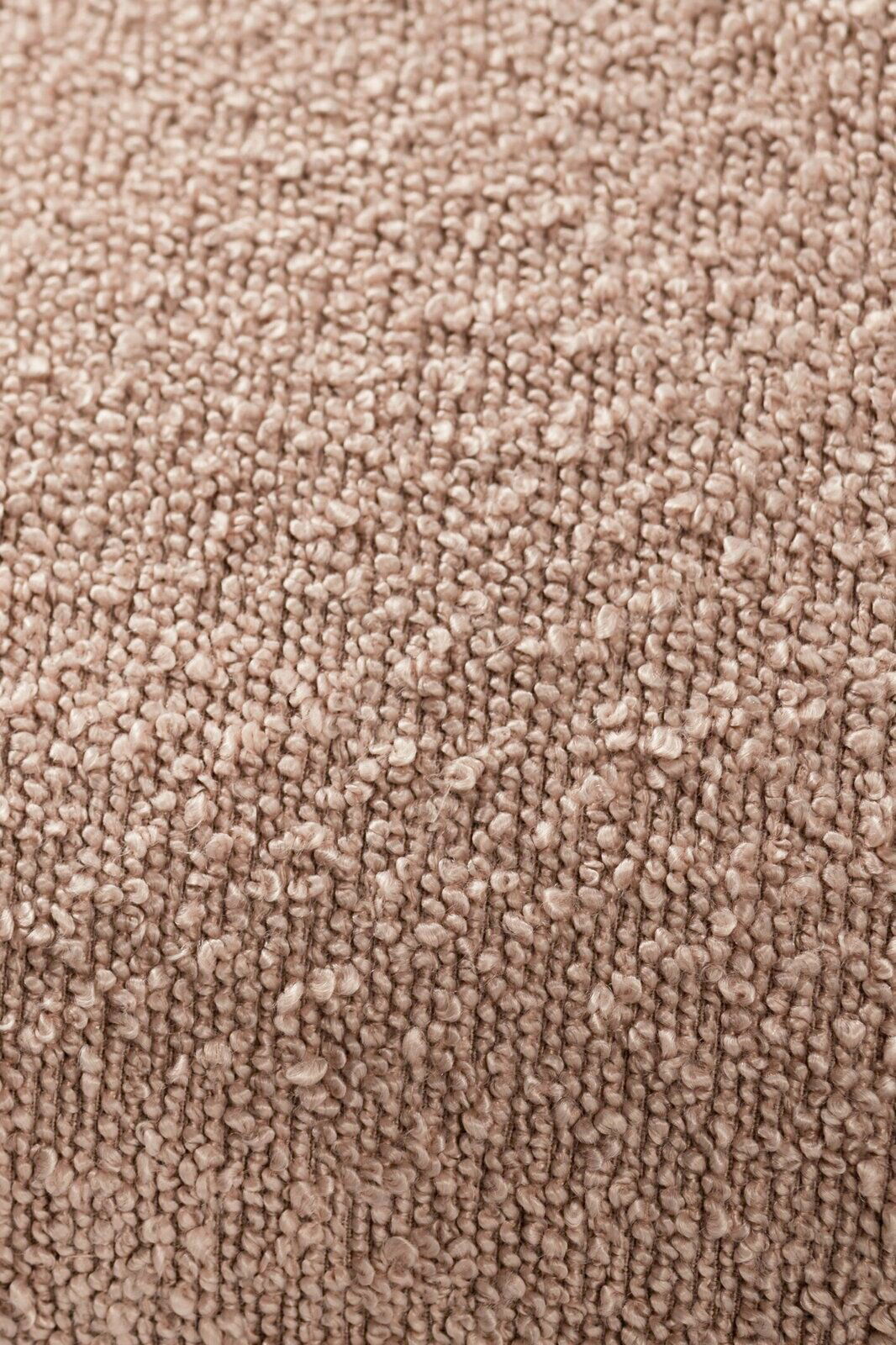 Nahaufnahme einer strukturierten, beigen Stoffoberfläche, vermutlich von einer Zierkissenhülle.