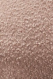 Nahaufnahme einer strukturierten, beigen Stoffoberfläche, vermutlich von einer Zierkissenhülle.