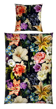 Wendebettwäsche mit lebendigem Blumenmuster auf schwarzem Hintergrund, aus der Vogelperspektive fotografiert.